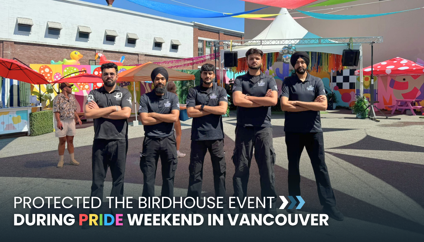 Five Blackbird Security event security guards stand in a line, facing the camera, conducting event security in Vancouver at The Birdhouse during Pride weekend.