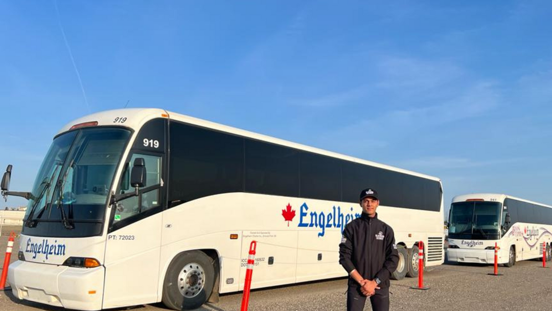 Uniformed Blackbird security guard in front of bus
