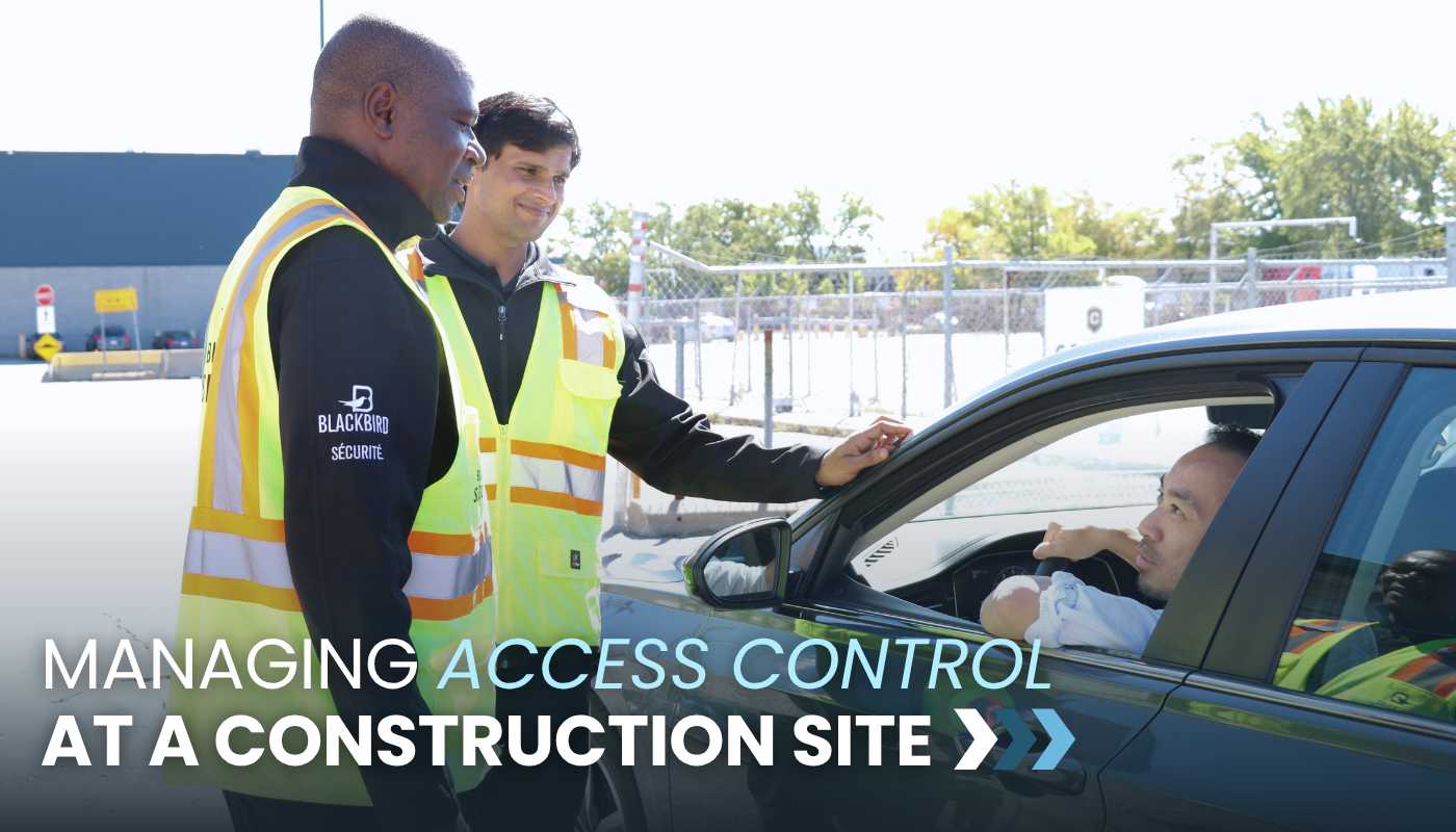 Two security guards speak to a man in a car.