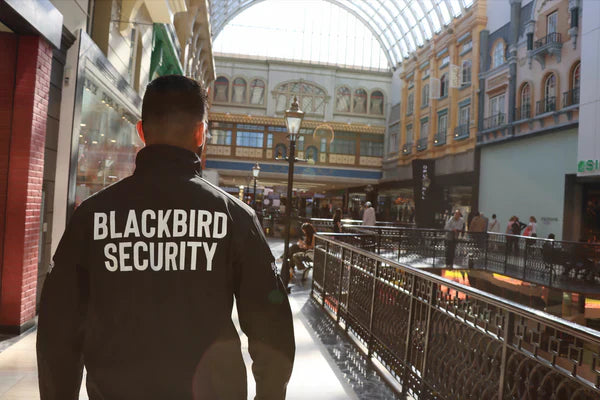 Blackbird Security guard walking through a shopping centre