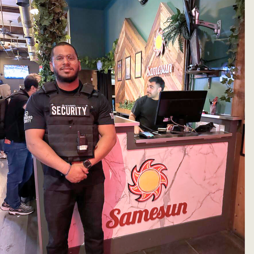 Blackbird security guard standing in front of reception desk at Samesun Hostel