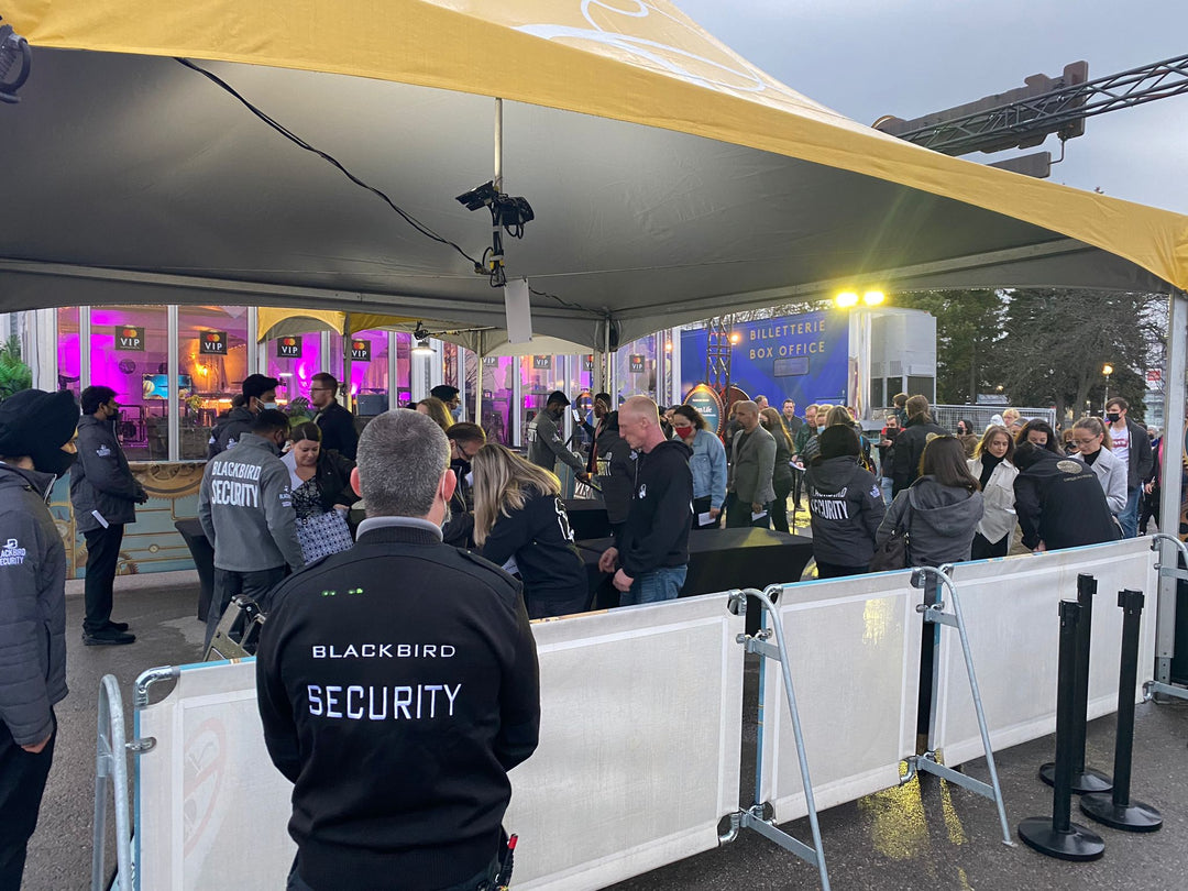 A Blackbird Security event security guard oversees a crowd entering a venue.