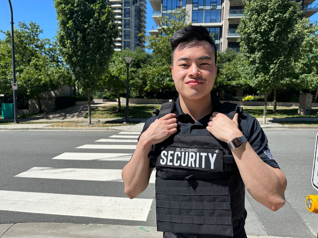 Uniformed Blackbird security guards standing in front of crosswalk
