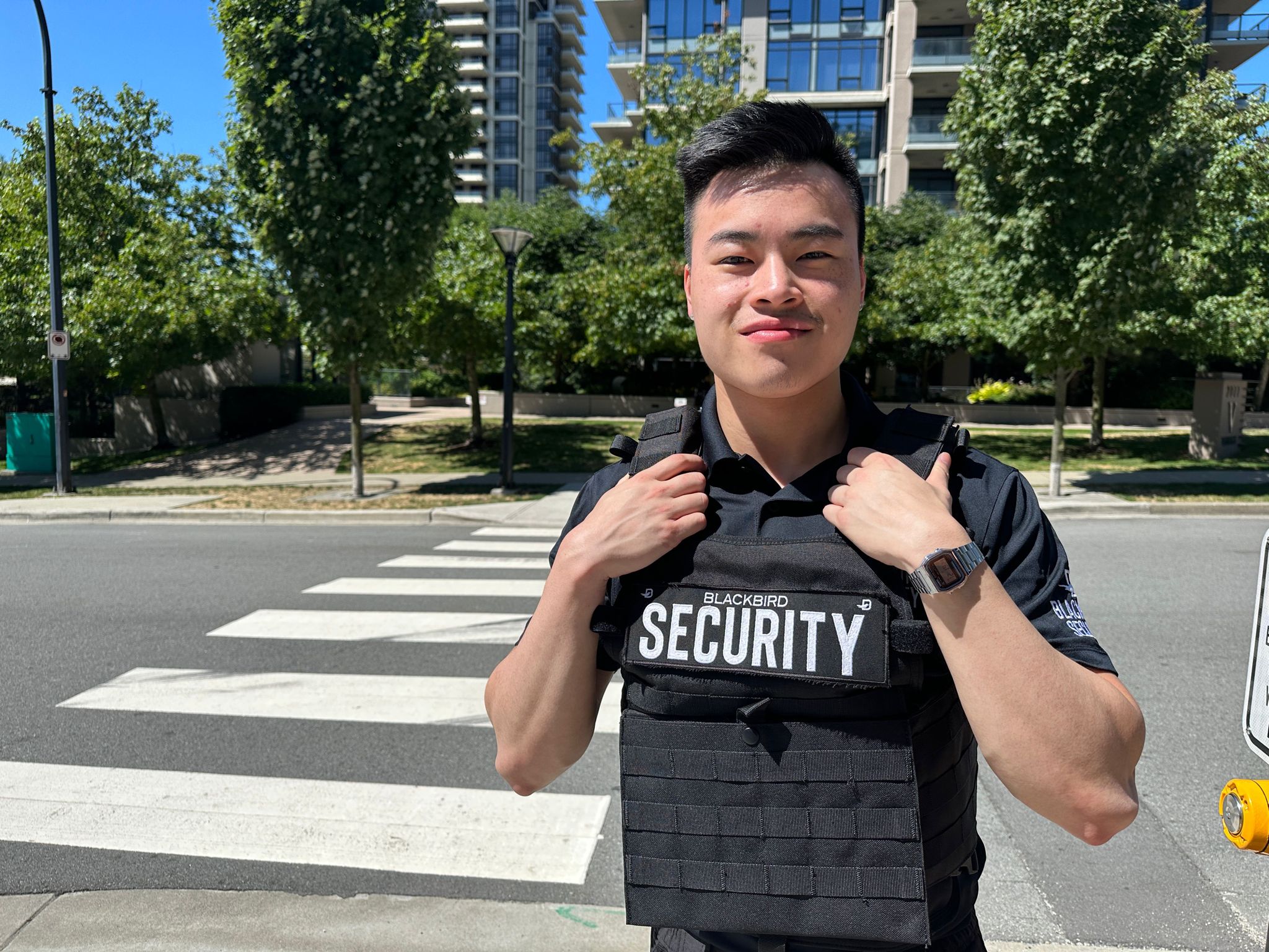 Uniformed Blackbird security guards standing in front of crosswalk