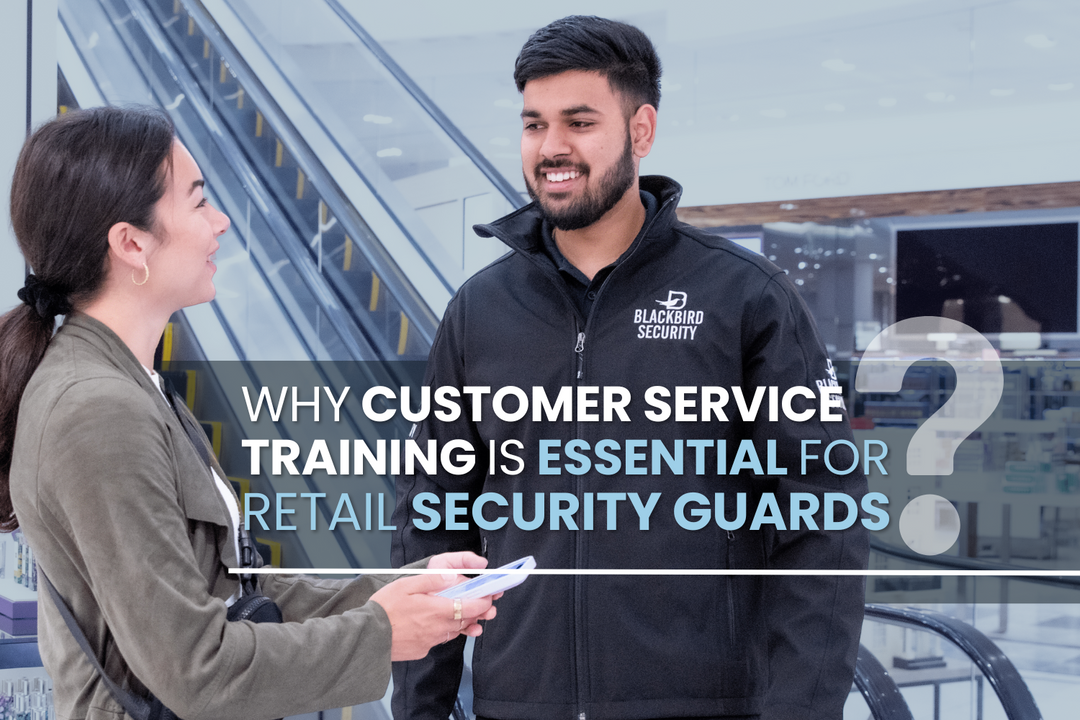 Male Blackbird Security guard in uniform speaking with woman in front of escalator