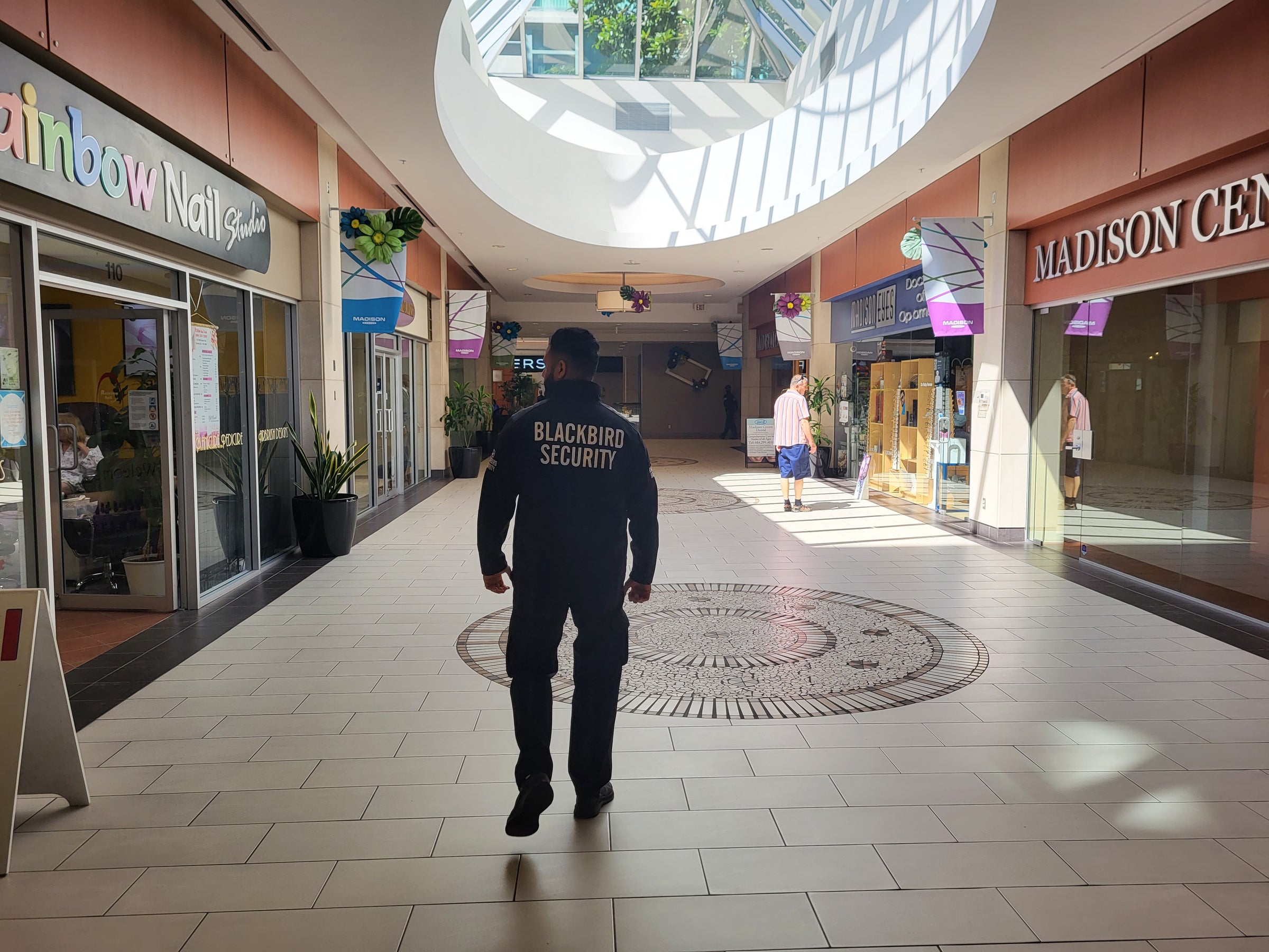 Uniformed Blackbird security guard patrolling mall