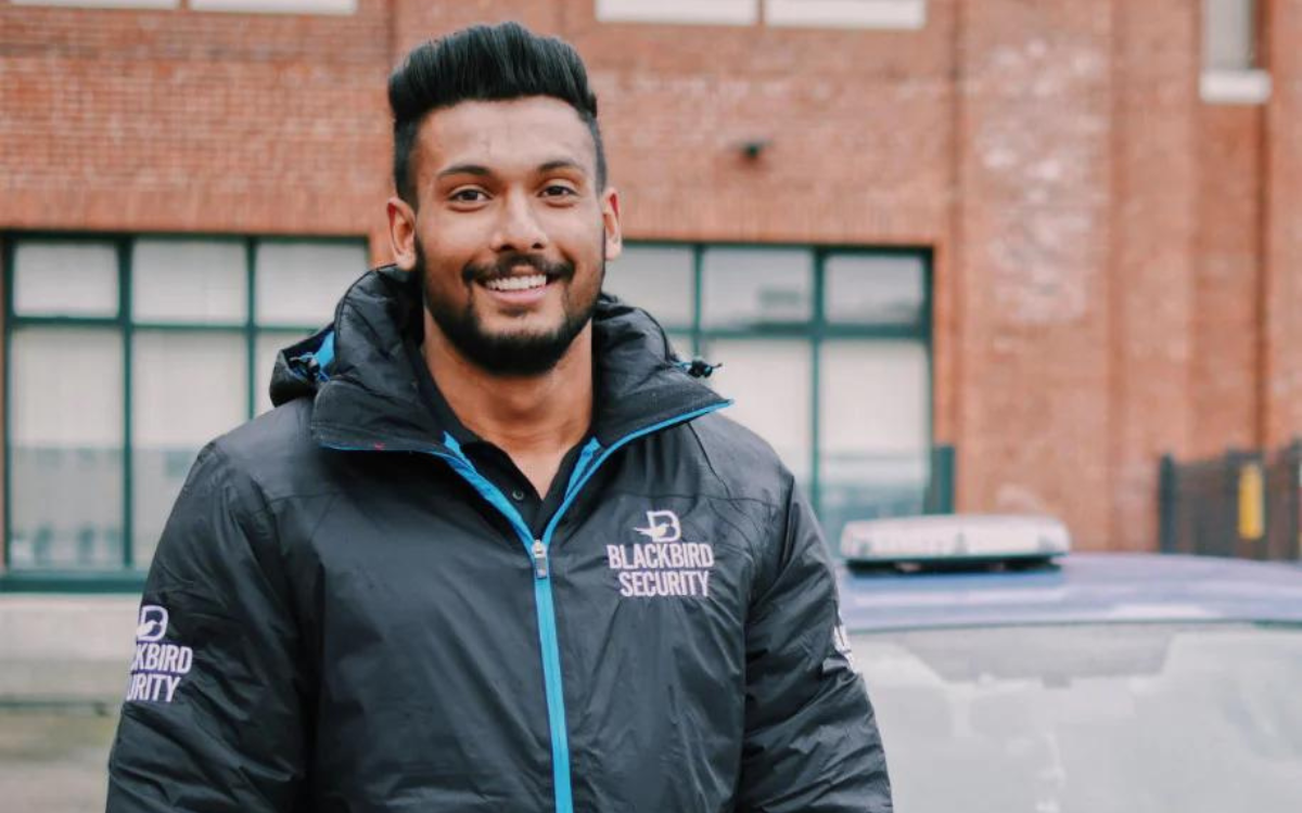 Blackbird security guard in front of building