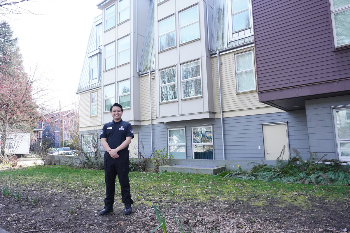 Uniformed Blackbird Security guard standing outside a building