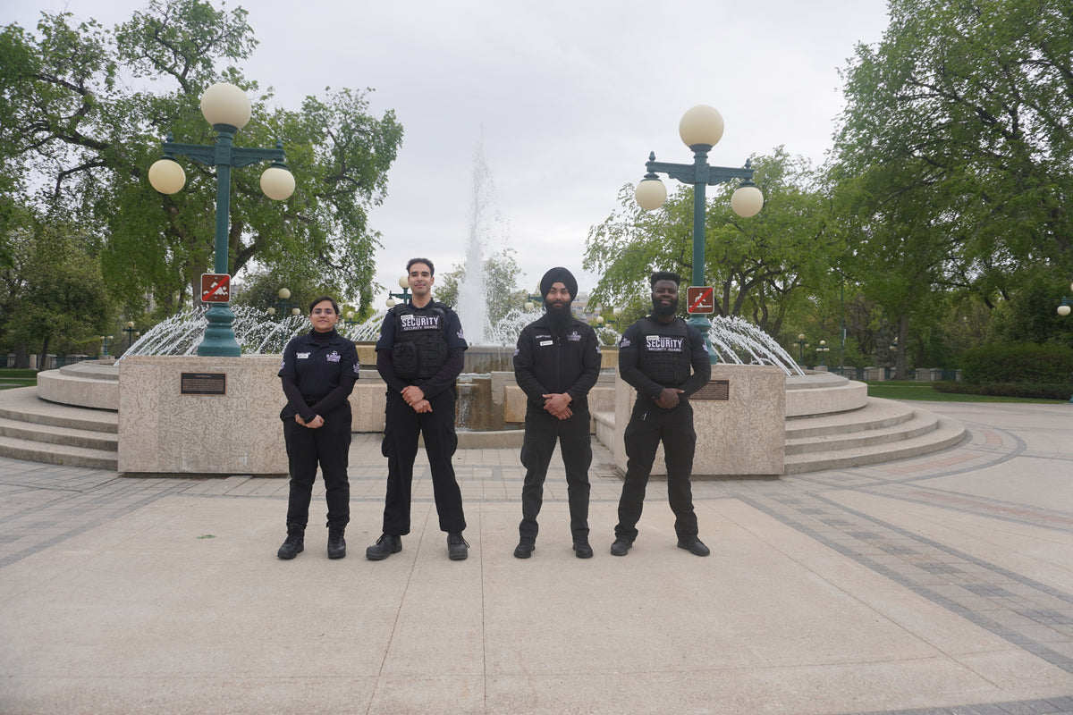 Four Blackbird security in front of water fountain