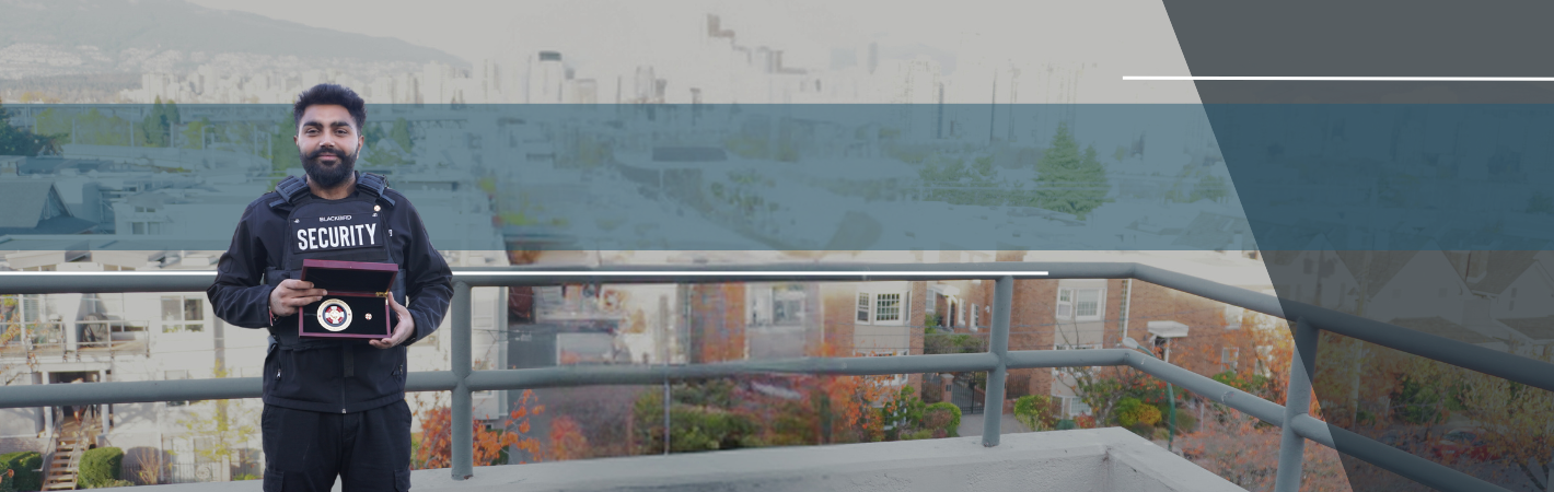Uniformed Blackbird security guard holding medal