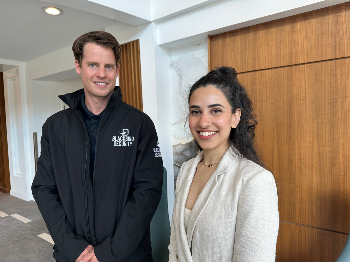 Blackbird security guard with woman in business suit