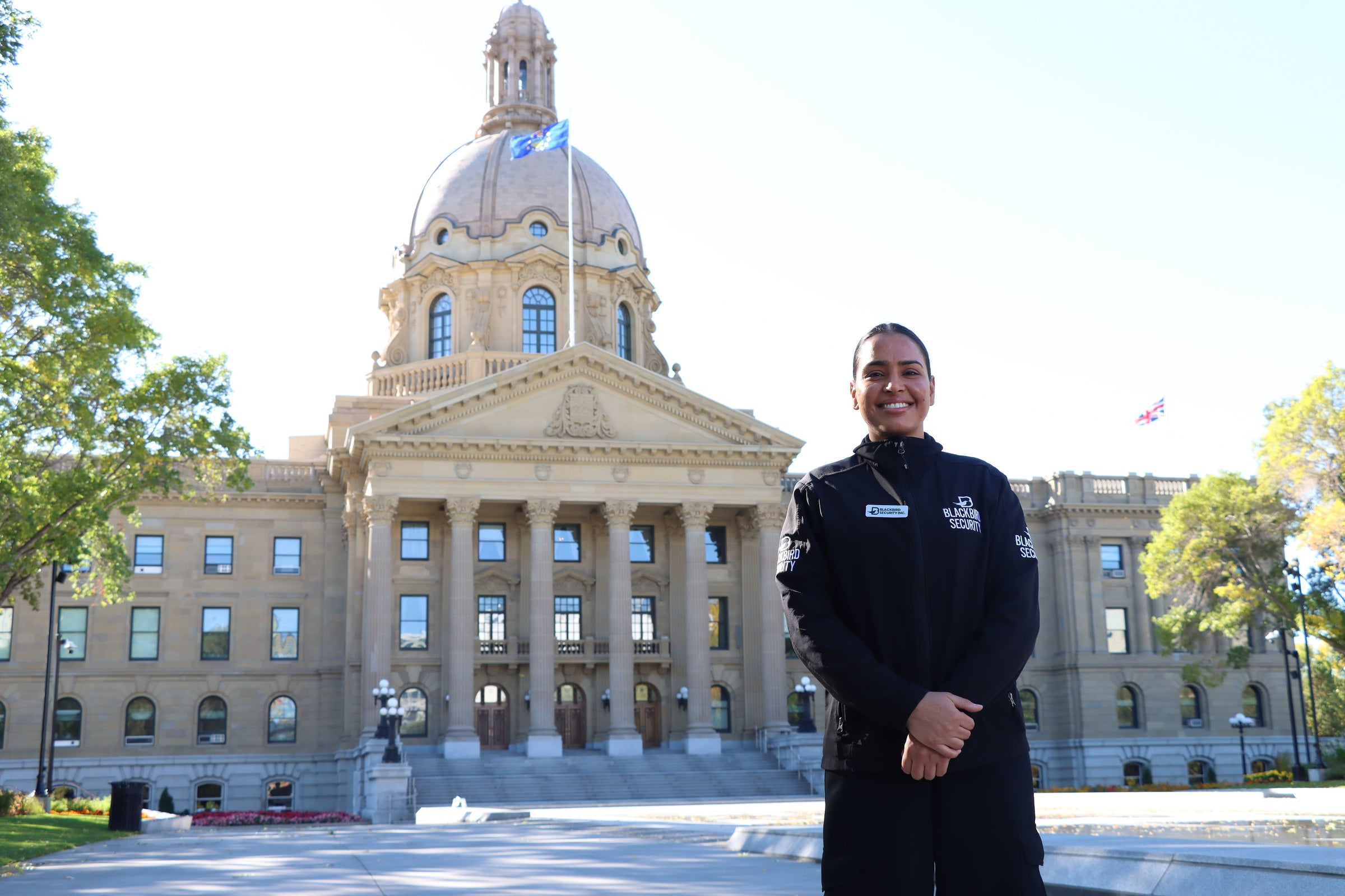 Blackbird Security Uniform Guard standing in front of the Alberta Legislative Building