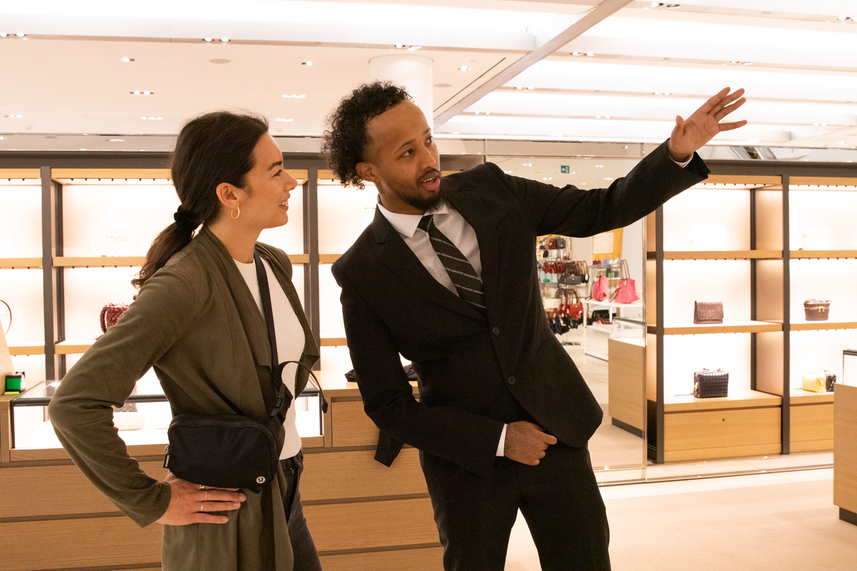 Plained Clothes Blackbird security guard in retail location giving directions to woman