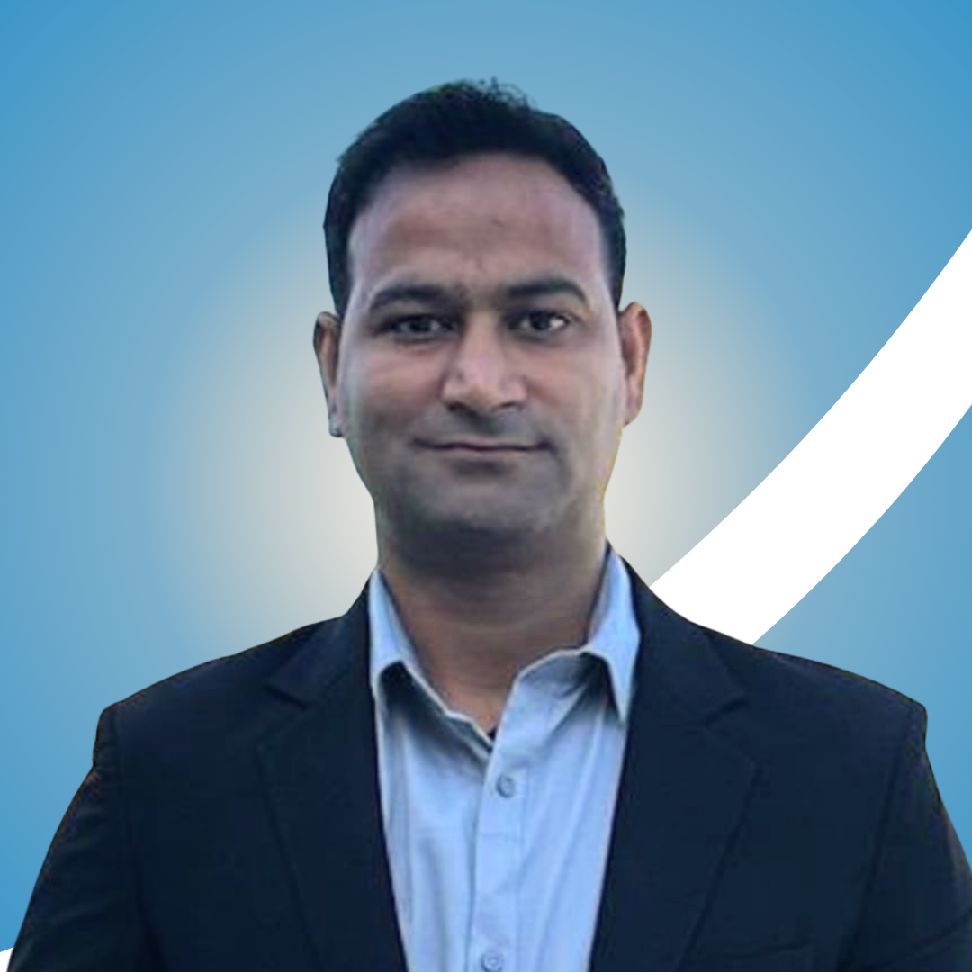 Man in a dark blazer over a light shirt with a blue background.