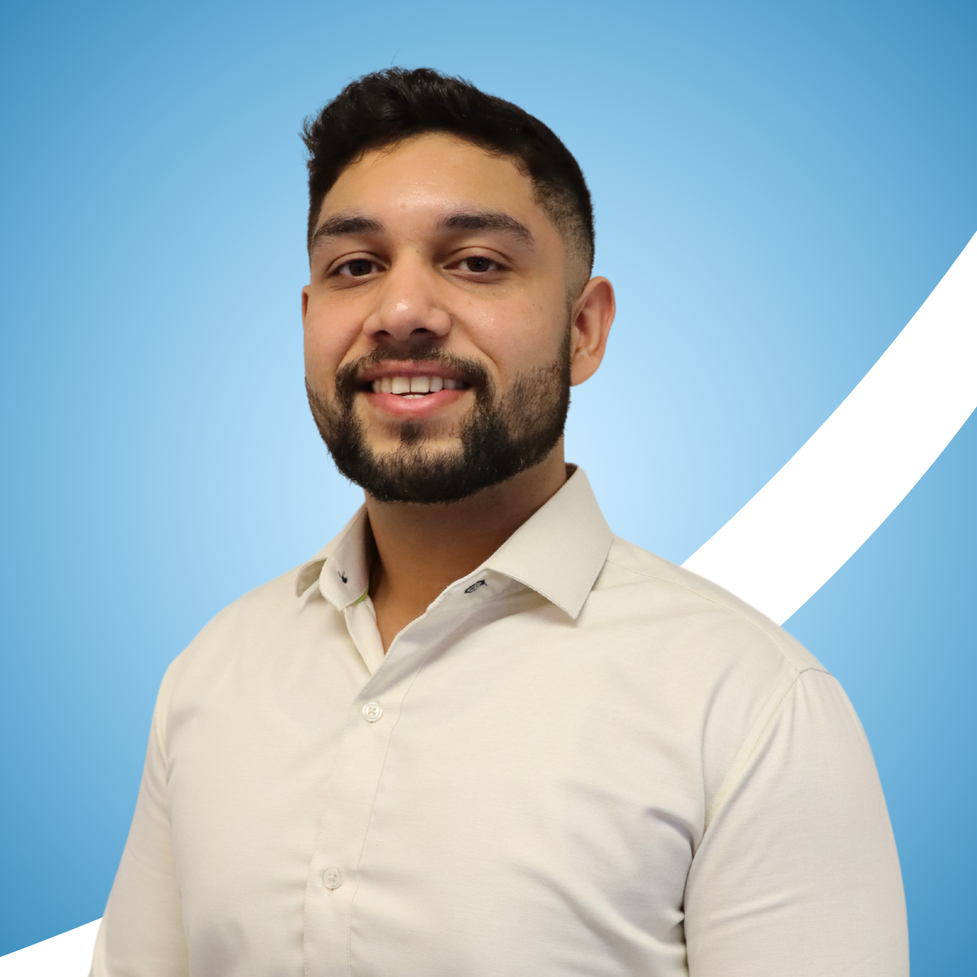 Man wearing a white shirt against a blue background