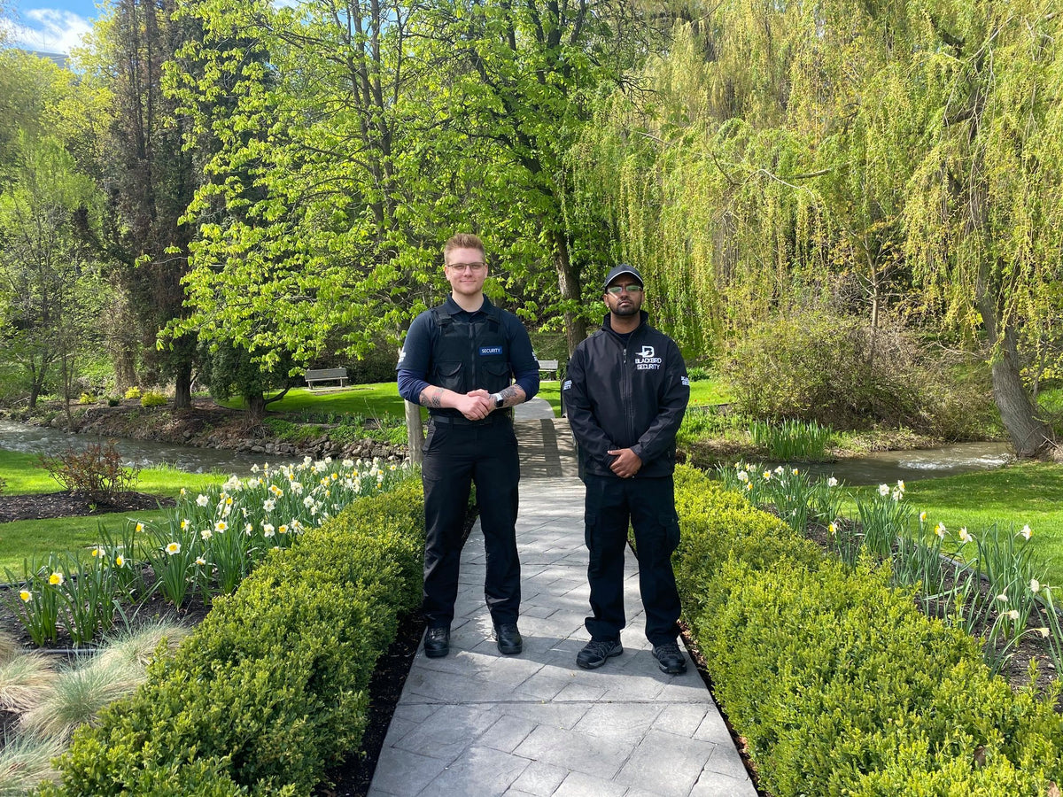 Two Uniformed Blackbird security guards on garden walkway