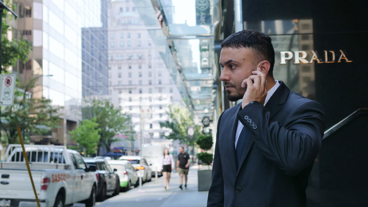 Blackbird Security officer listening to ear piece in front of Prada Vancouver