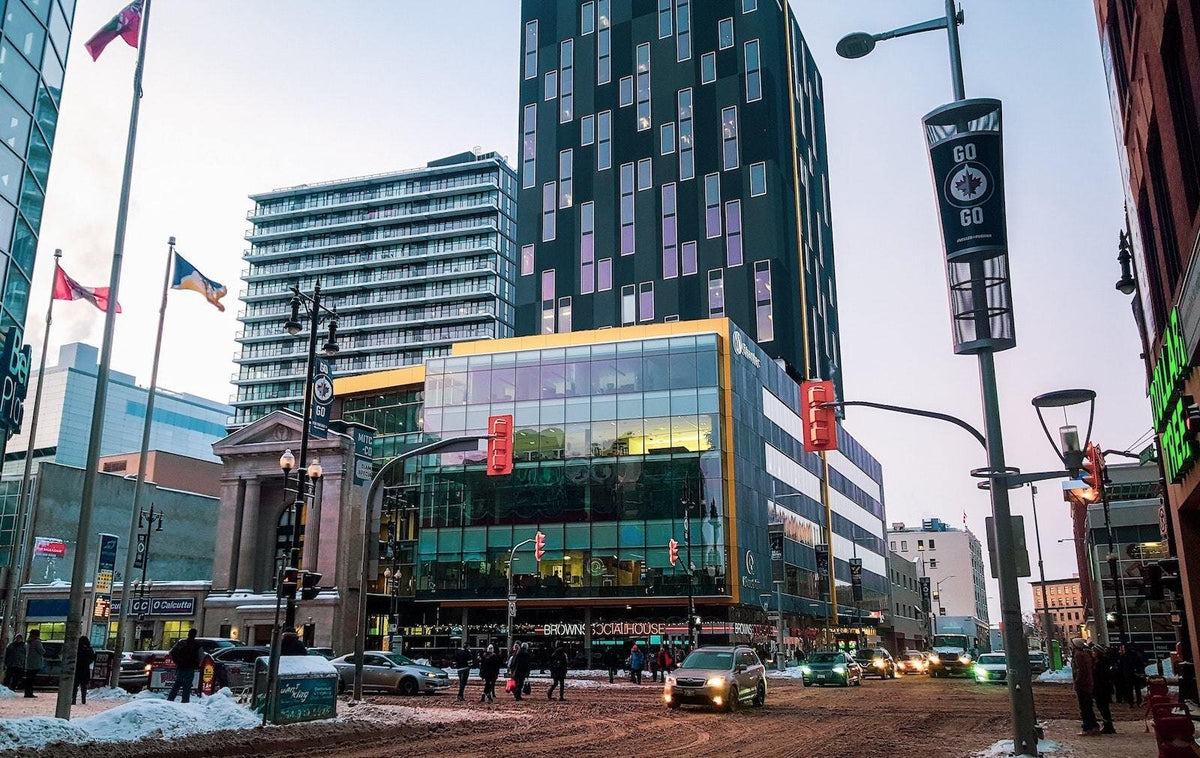 Winnipeg downtown street in winter with cars and people